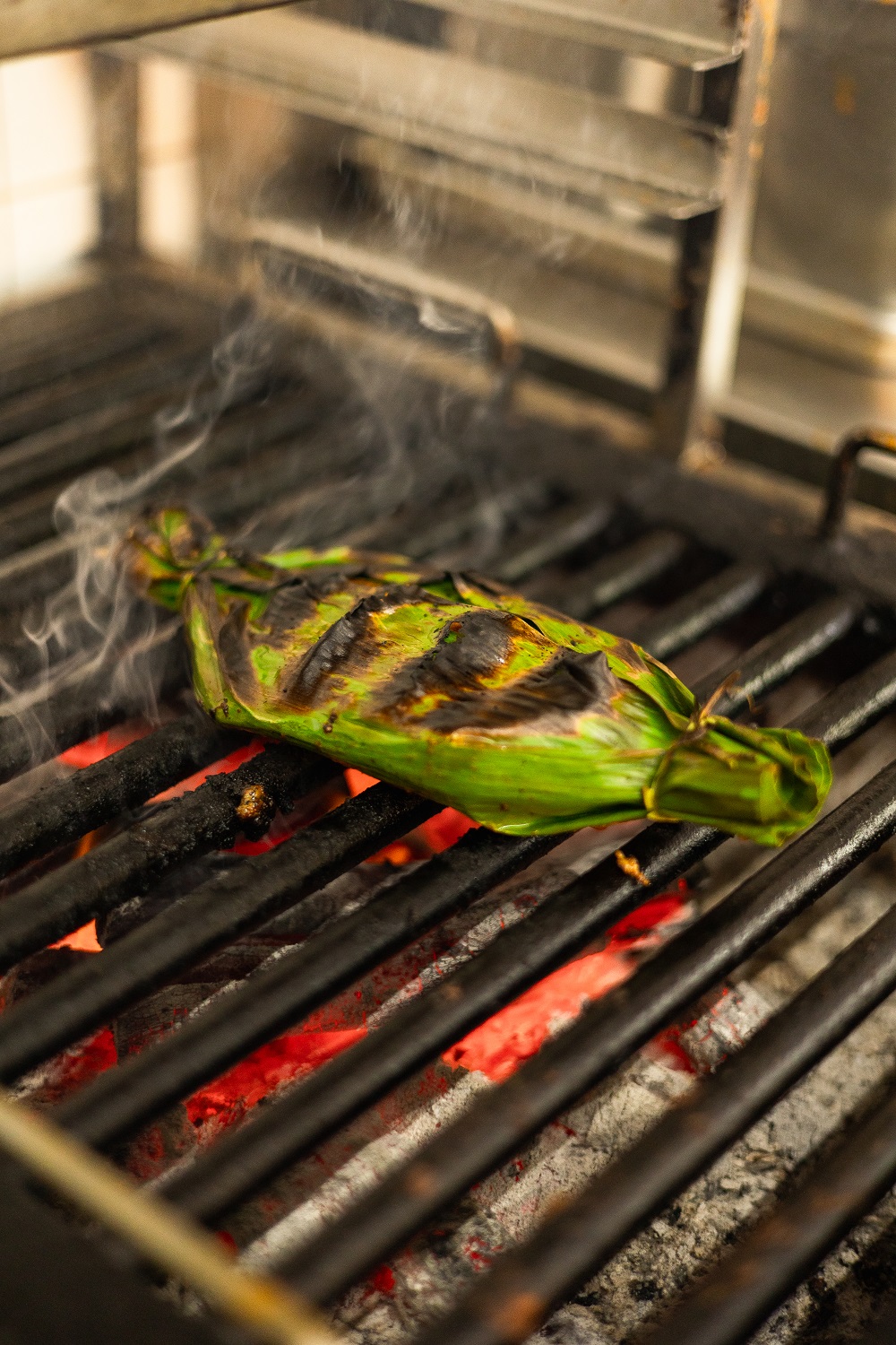 Grilling fish in banana leaf